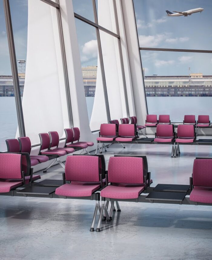 Kind Beam Seating groups of 2 seater modules with integral black tables shown in an airport lounge