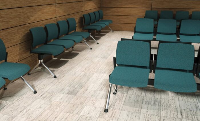 Kind Beam Seating rows of 4 seater modules with upholstered seats and backs in a waiting room