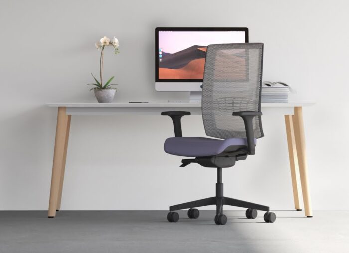 Kind Mesh Task Chair with arms, grey mesh back and black base in front of a desk
