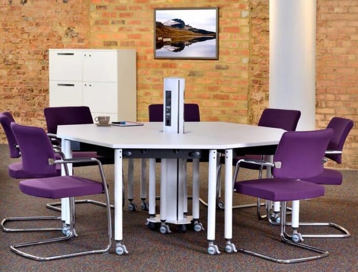 Kite Folding Tables in a round configuration shown in an office space