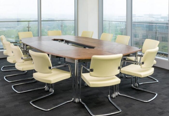 Kite Folding Tables in an oval configuration shown in a meeting room