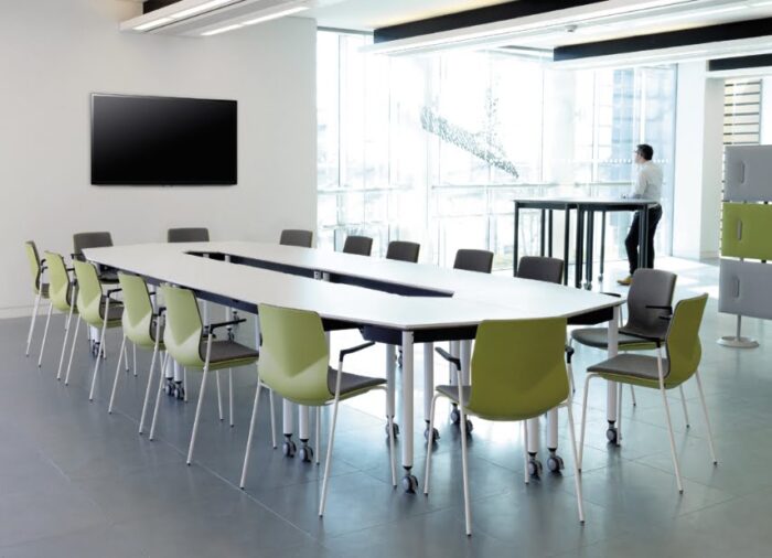 Kite Folding Tables with white straight legs shown in a meeting space