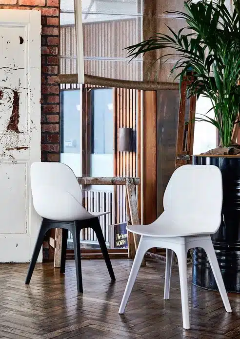 LG4 Plastic Seating two chairs with white plastic shells, one with white 4 leg frame and the other with black 4 leg frame