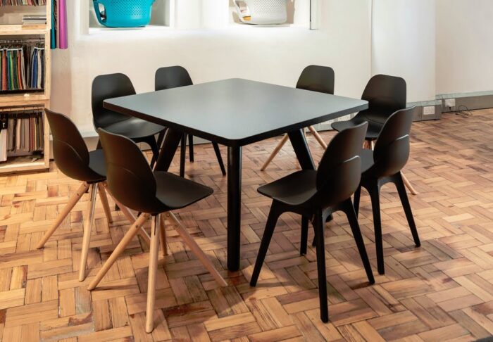 LG4 Wood Seating 4 wood leg and 4 plastic leg chairs shown around a square meeting table