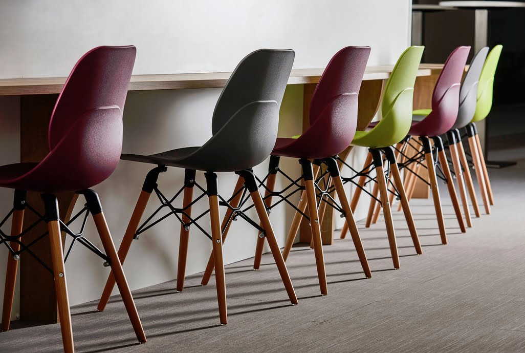 LG4 Wood Seating 7 poseur height chairs in a row in front of a breakfast bar