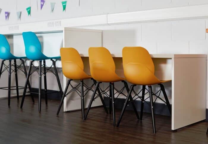 LG4 Wood Seating diner height and poseur height chairs in a row by low and high bench tables