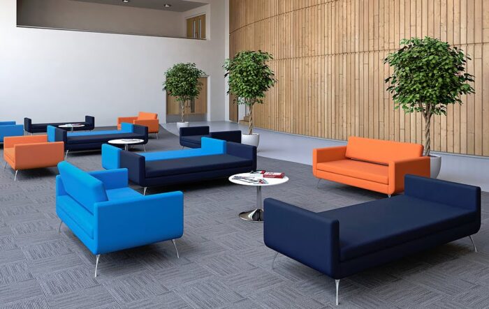 Liberty Soft Seating groups of sofas and armchairs with backs, bench sofas with no backs and chrome legs shown with low tables in a breakout area