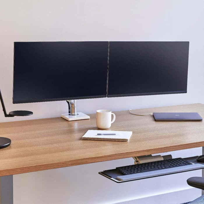 M8.1 Monitor Arm With Crossbar and dual screens mounted on a desk