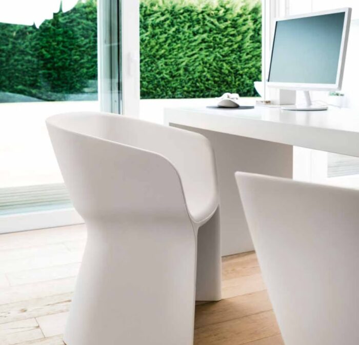 Margarita Chair two polyethylene chairs in white shown in front of a desk