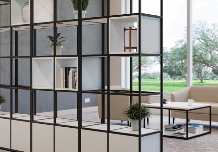 Matrix Storage with a black grid frame, white shelving and box units shown in a lounge area