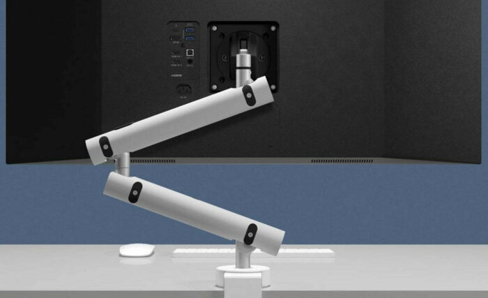 Miro Monitor Arm In White Mounted On Desk Shown From The Rear