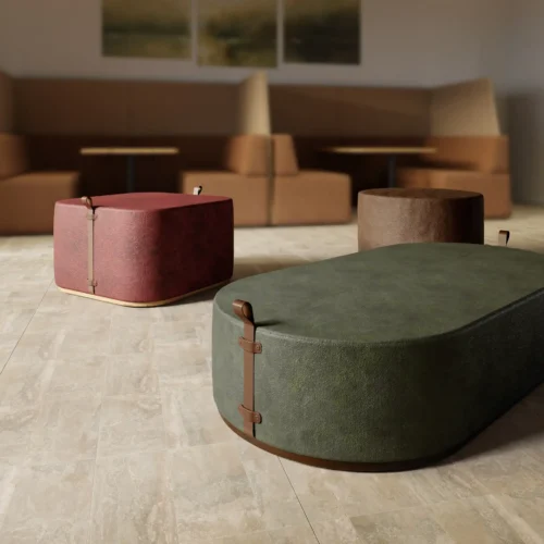 Warm lounge area with large green Moat Pouffe in the foreground; brown modular sofas in the background.