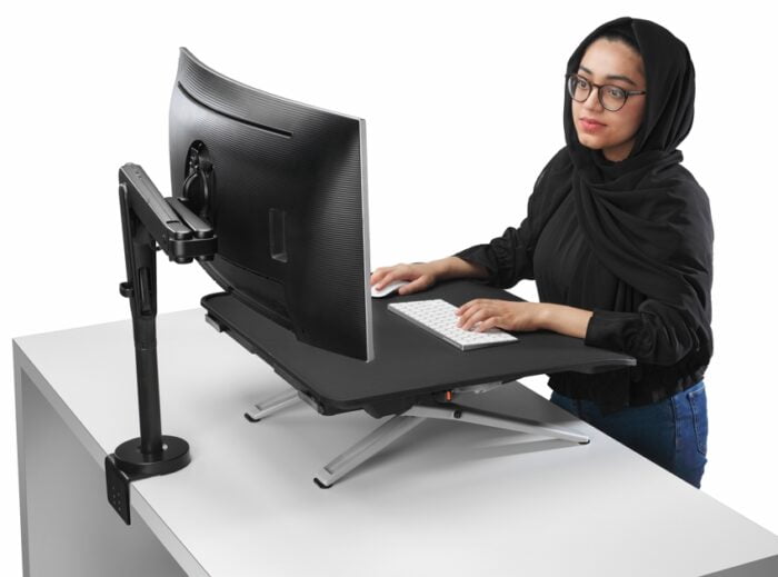 Monto Sit Stand Riser shown being used on a fixed height desk