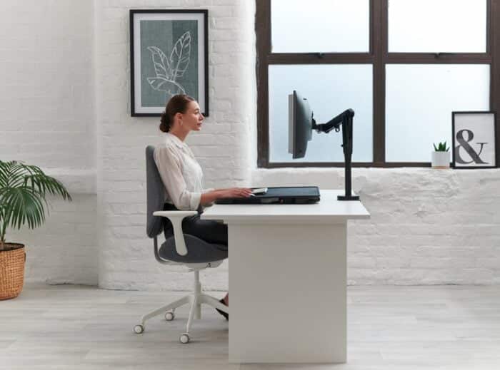 Monto Sit Stand Riser shown in flat position on an office desk