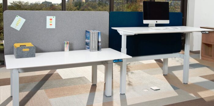 Mount Sit-Stand Desk two double sided units in white finish shown in a workspace