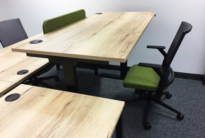 Move3 Height Adjustable Desks - close up view of back to back bench desk tops