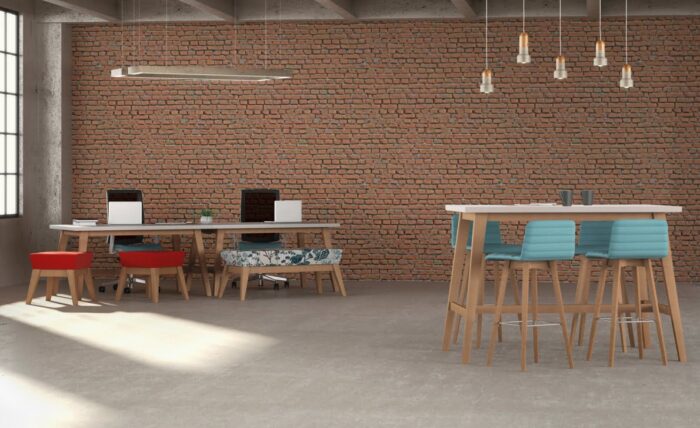 Natta Breakout Table And Bench low and high tables shown in a work space with high and low stools and task chairs