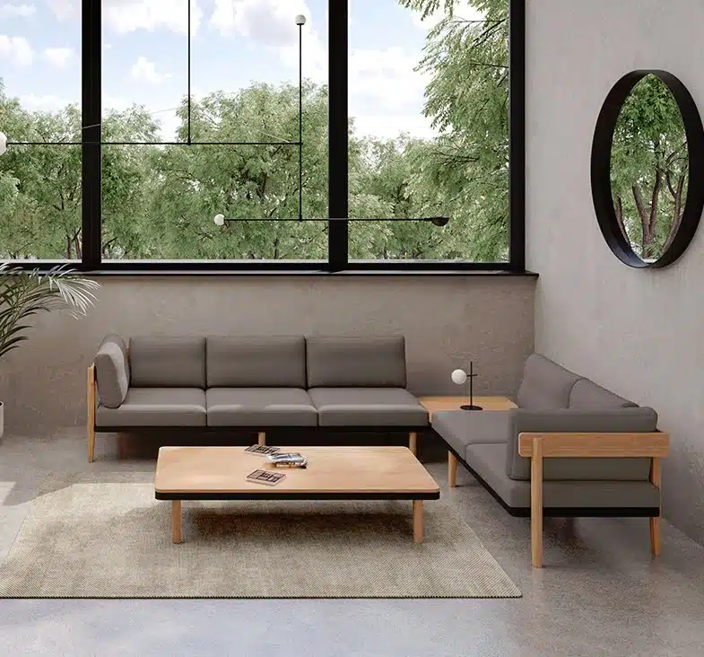 Neve Seating corner configuration comprised of a 3 seat sofa with right hand arm and a 2 seat sofa with left arm and right hand table shown with a double free standing table in a breakout space