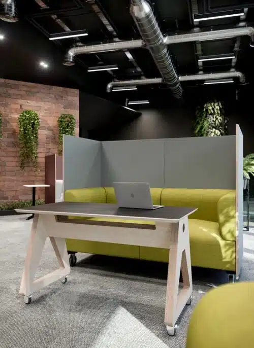 Nomad Mobile Furniture high birch ply surround two seater on castors shown with a matching table in an office space