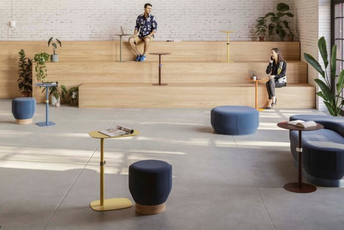 Nota Table several round and rectangular tables scattreed around in a meeting space with tiered seating