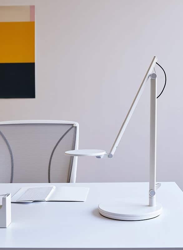 Nova Task Light in white, shown on a desk in a work space
