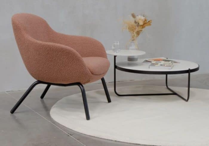 Orbit Coffee Table with black frame and white lollipop tops shown by a lounge chair