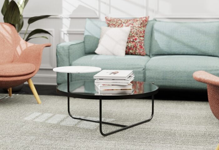 Orbit Coffee Table shown with books on lower top in a lounge area with chairs and a sofa