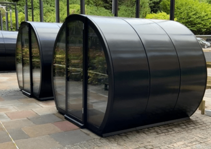 Outdoor Meeting Pod two 6 seat pods with glass doors shown in an outside space