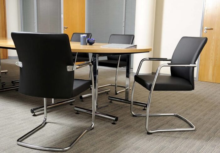 Panache Meeting Chair full back chairs with chrome cantilever frames and black leather upholstery around a meeting table