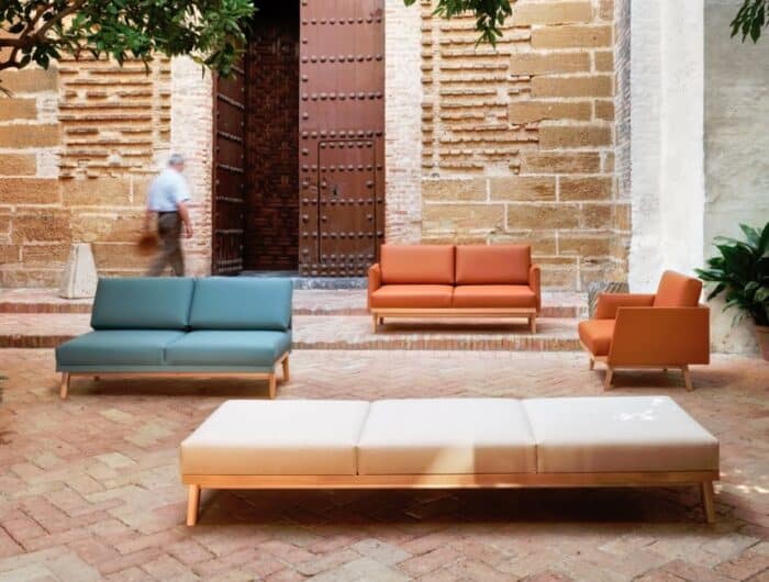 Pausa Modular Seating armchair 3 seater sofa with arms, 2 seater sofa and a 3 seater bench shown in an outdoor space