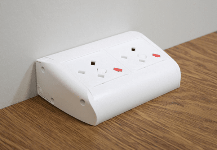 Pearl Power Module showing a white horizontal unit with two UK power sockets on a desktop