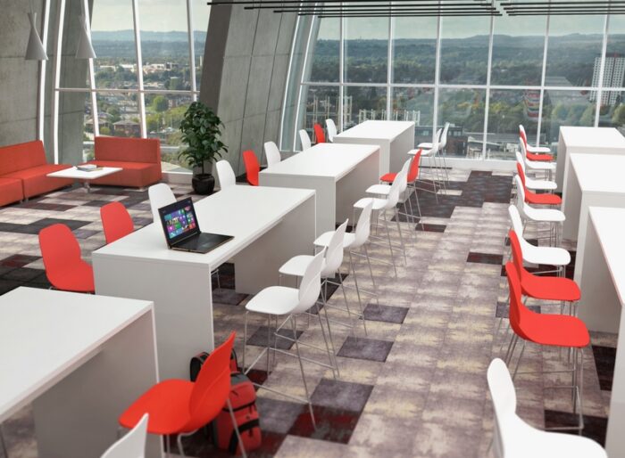 Planar Table - two rows of poseur height tables in white, shown with high chairs in an office space