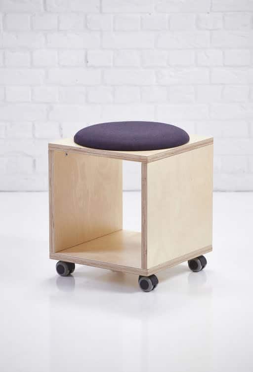 Platforms Box Stool with upholstered padded seat and black castors