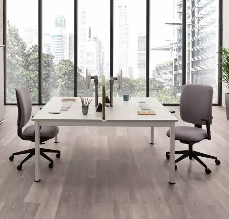 Pluto Plus Task Chair two chairs with adjusable arms and black bases on castors by a bench desk in a work space