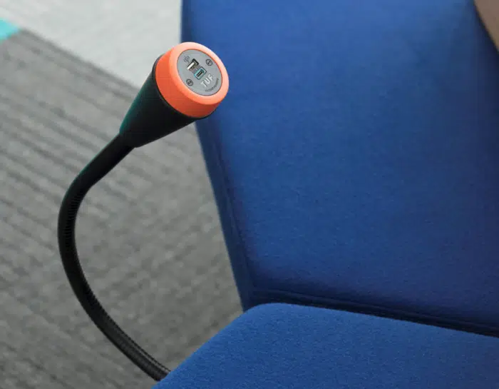 Pose Power Modules bespoke module with orange bezel and black gooseneck shown attached to a chair