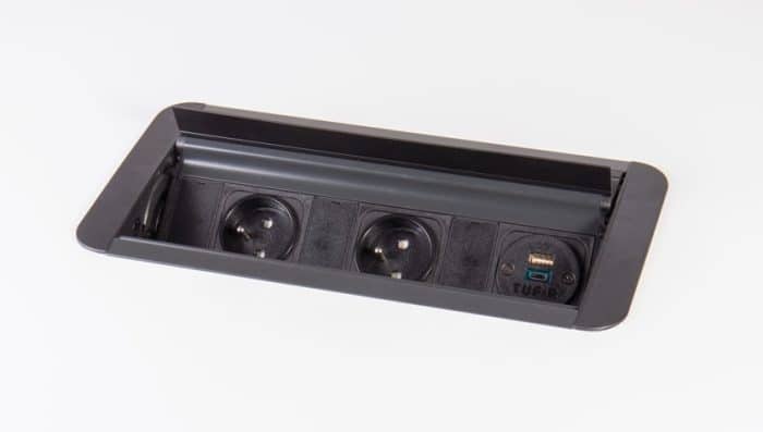 Prism Power Module shown open, in all black finish with two schuko power sockets and twin USB charging sockets