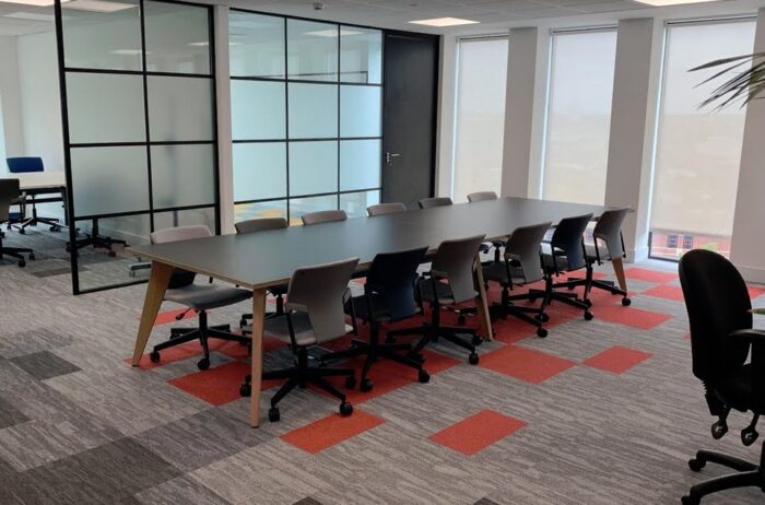 Pyramid Conference Tables 12 seater table with wood frame shown in a meeting space