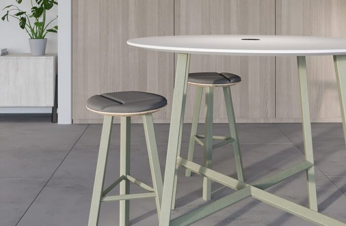 Relic Breakout Table circular 4 leg poseur table wtih cutline top and green frame shown with high stools in matching colours