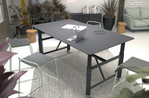 Relic Project Table rectangular height adjustable table on castors shown with a black top and frame in a workspace