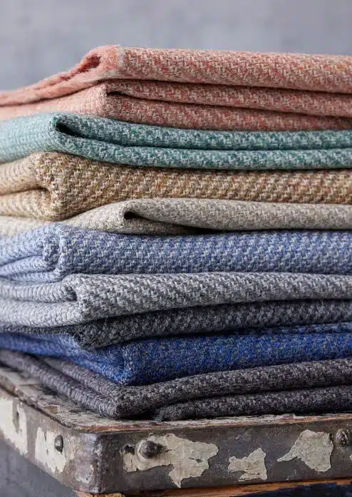 Revolution Fabric stack of folded fabric in 9 colour ways