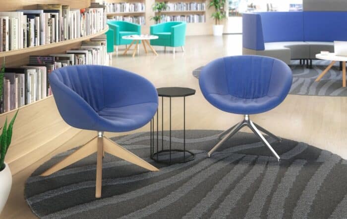 Ripple Tub Chair two low back chairs , one with raised wooden base and the other with an aluminium 4 star base shown in a lounge area