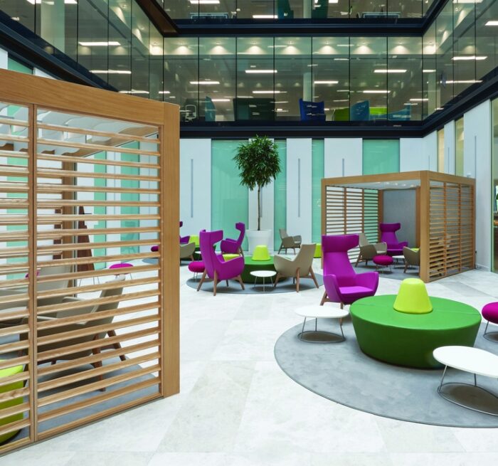 Rooms Collaboration Space two units with venetian trellis walls shown wtih soft seating units in a large breakout space