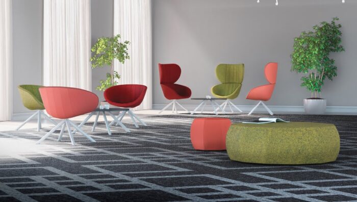Runna Seating high back and low back chairs shown with poufs and coffee tables in a breakout space