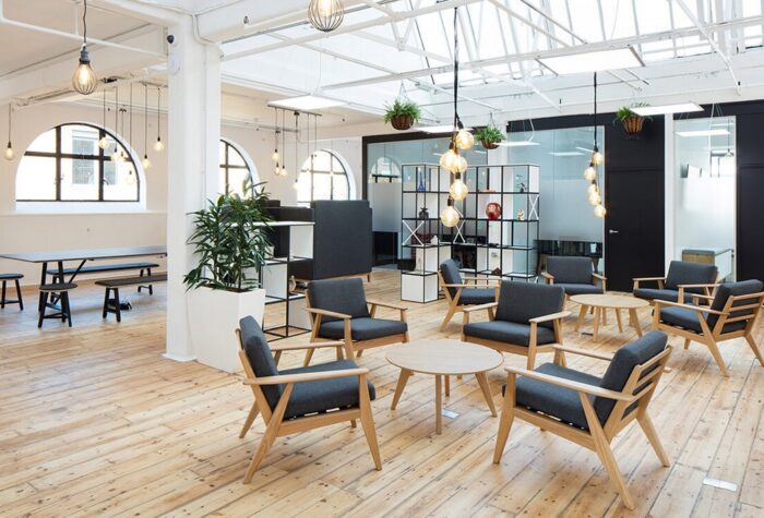 Scandi Lounge Chair groups of chairs with natural oak frames shown with coffee tables in an open plan office space