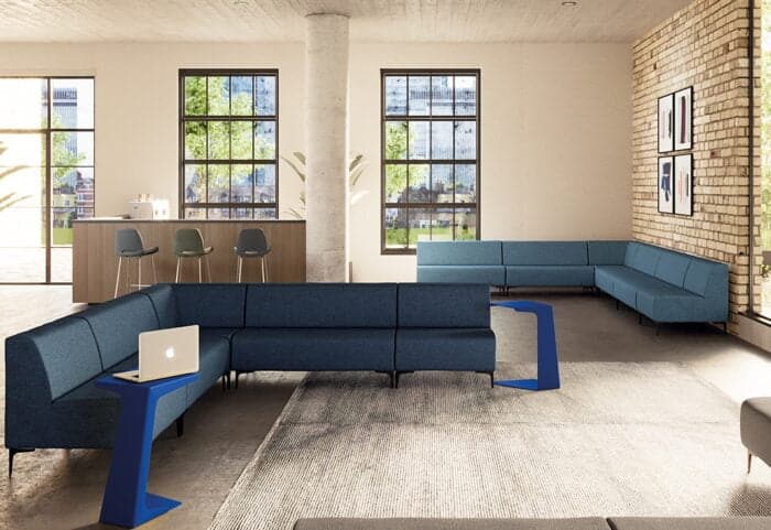 Huddle Modular Low Back Seating two L shaped corner configurations shown with freestanding laptop tables in a lounge area