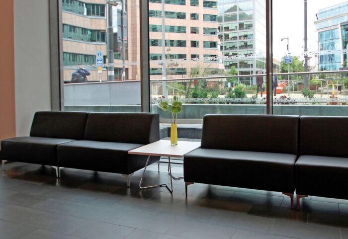 Huddle Modular Low Back Seating two two seat straight units shown with a coffee table in a reception space