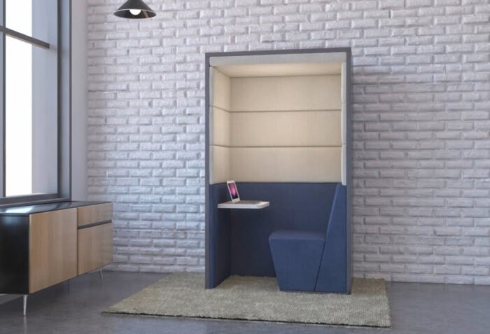 Session Booth single seater phone booth with flat roof, seat and work surface shown in a work place