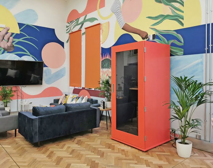 Shoreditch Phone Booth shown with some soft seating units and a TV in a breakout space