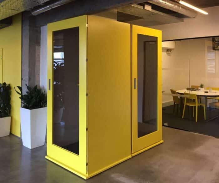Shoreditch Phone Booth two booths in yellow shown side by side in an open plan office space