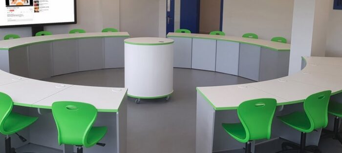 Sigma Computer Station shown in the centre of a curved desk configuration in a meeting room